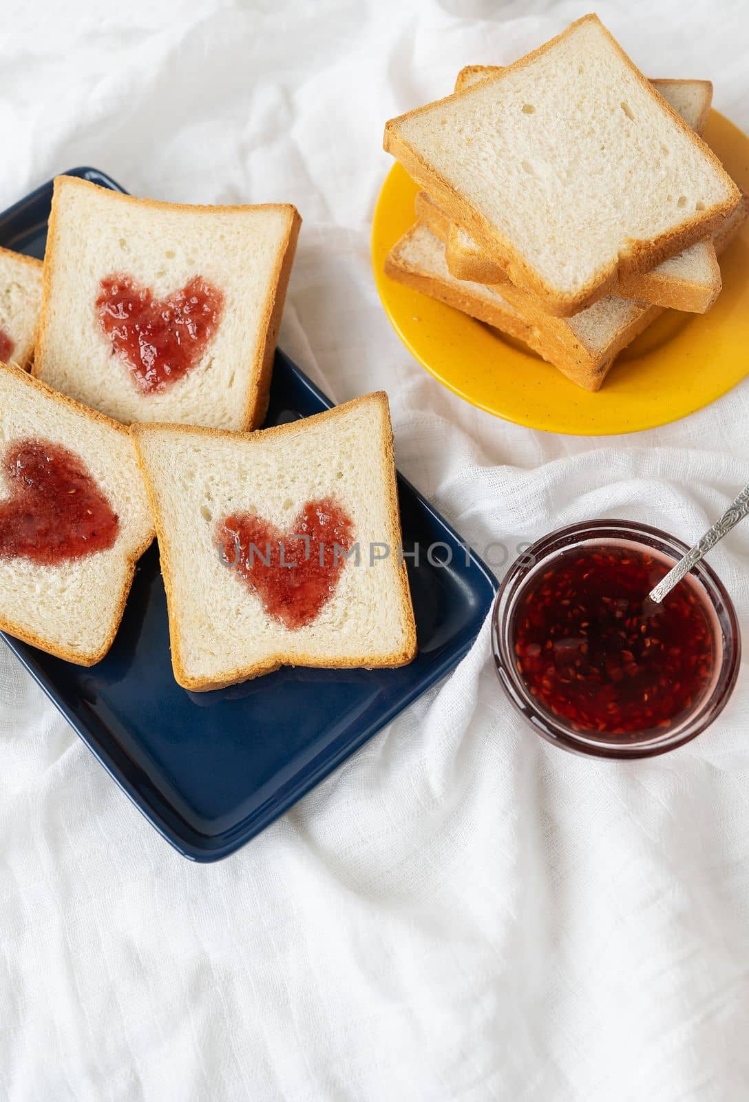 Toast on which the heart is made of jam. Surprise breakfast concept in bed. Romance for St. Valentine's Day