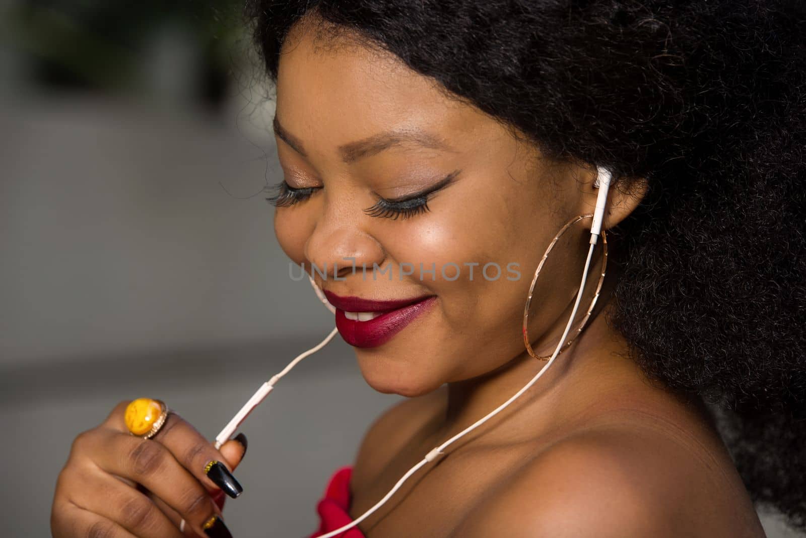 young woman talking on cell phone with earphone outside