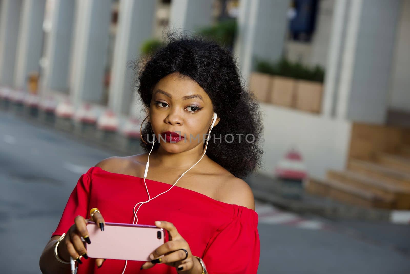 Beautiful young woman using laptop on a modern mobile phone with screen to copy text promotional content...
