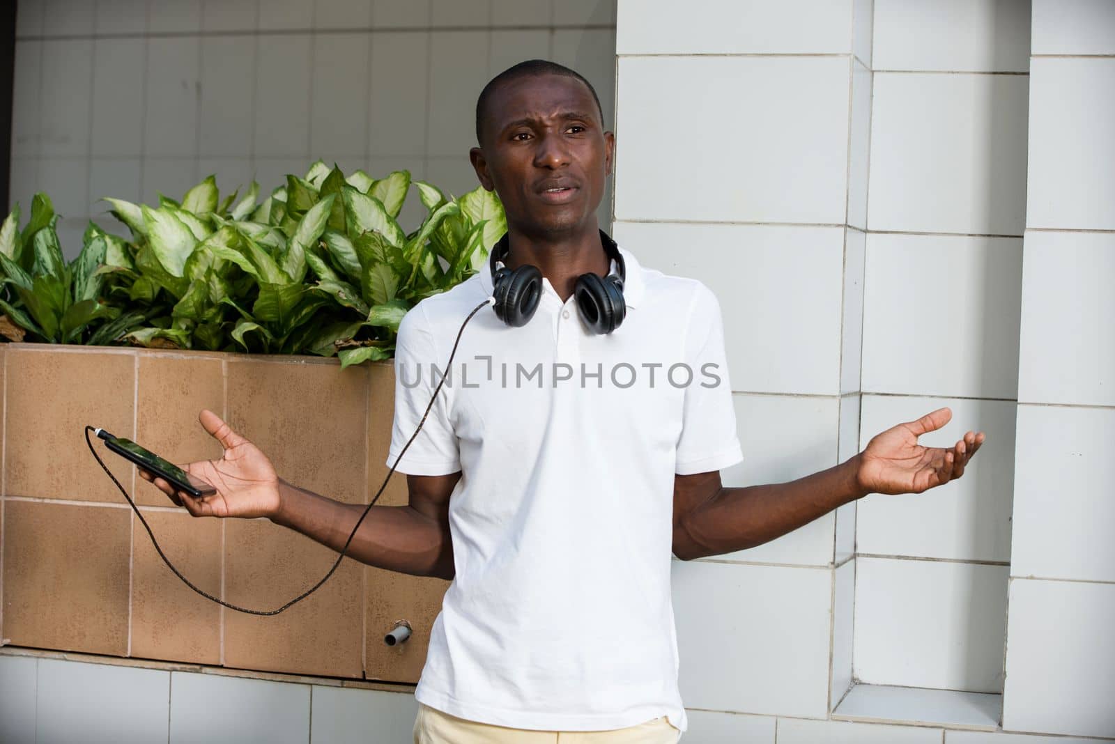 young man wearing a helmet with an expression of surprise standing outside