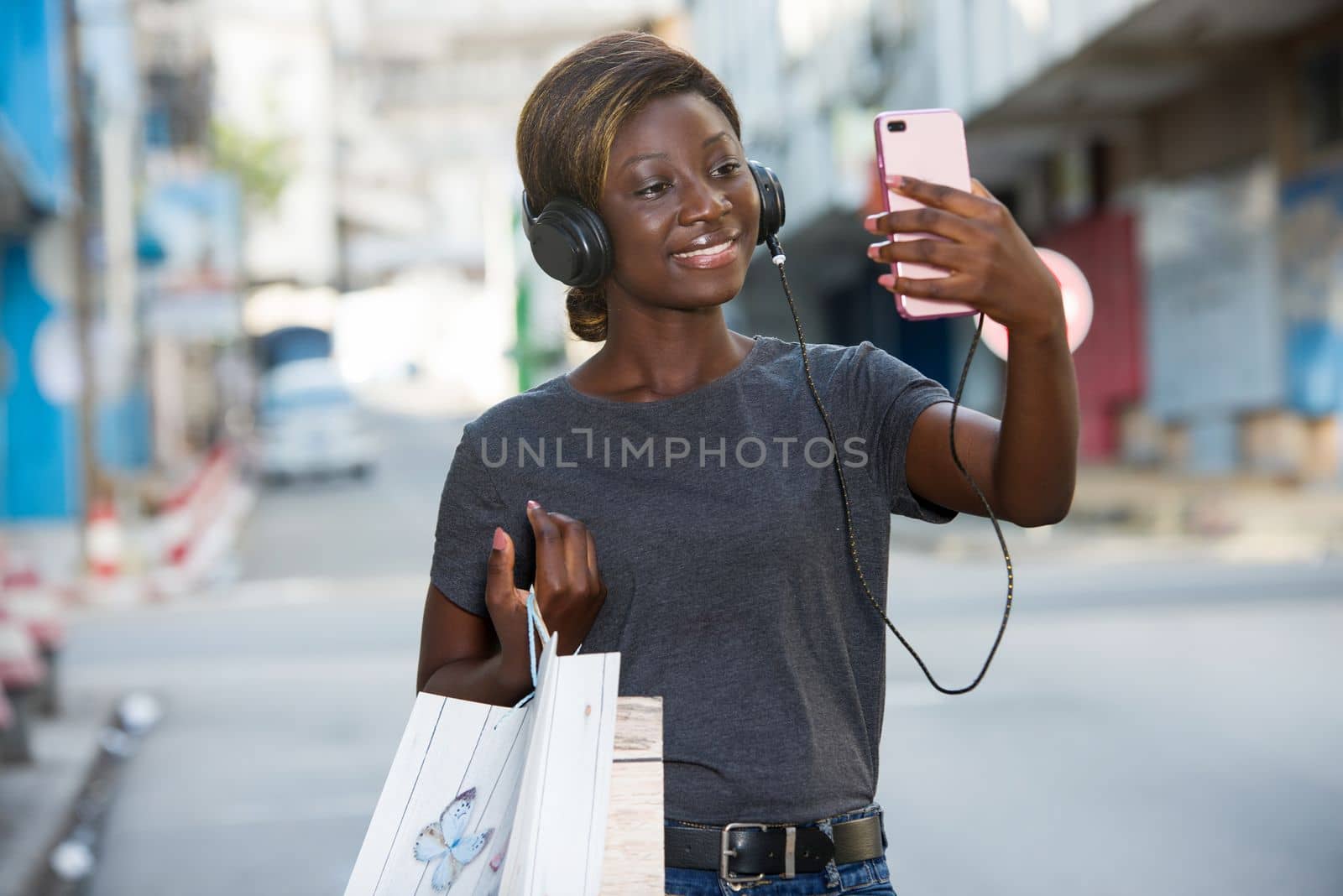 happy woman taking selfie with colorful bags by vystek