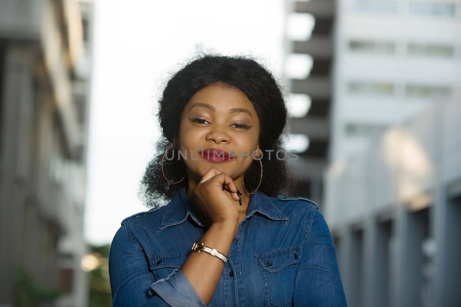 Young woman surprised in the street because of some news. She walks in the street and has the good mood