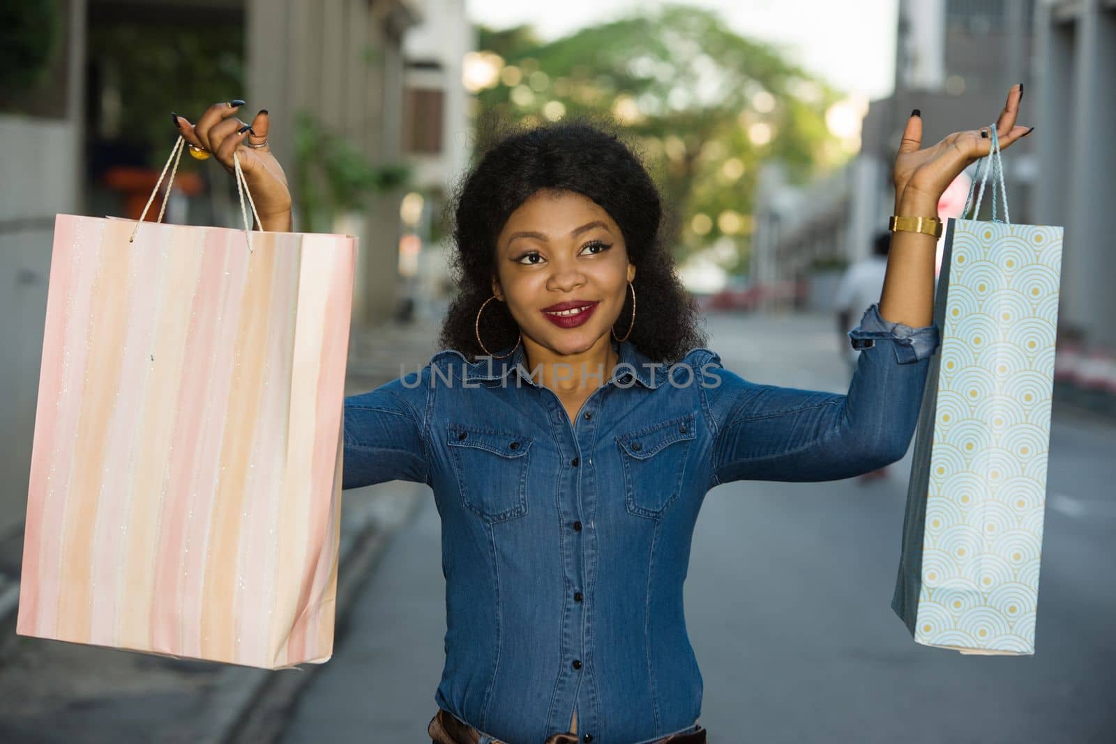 Happy Shopping, beautiful young woman holding bags on the street buying in the city.