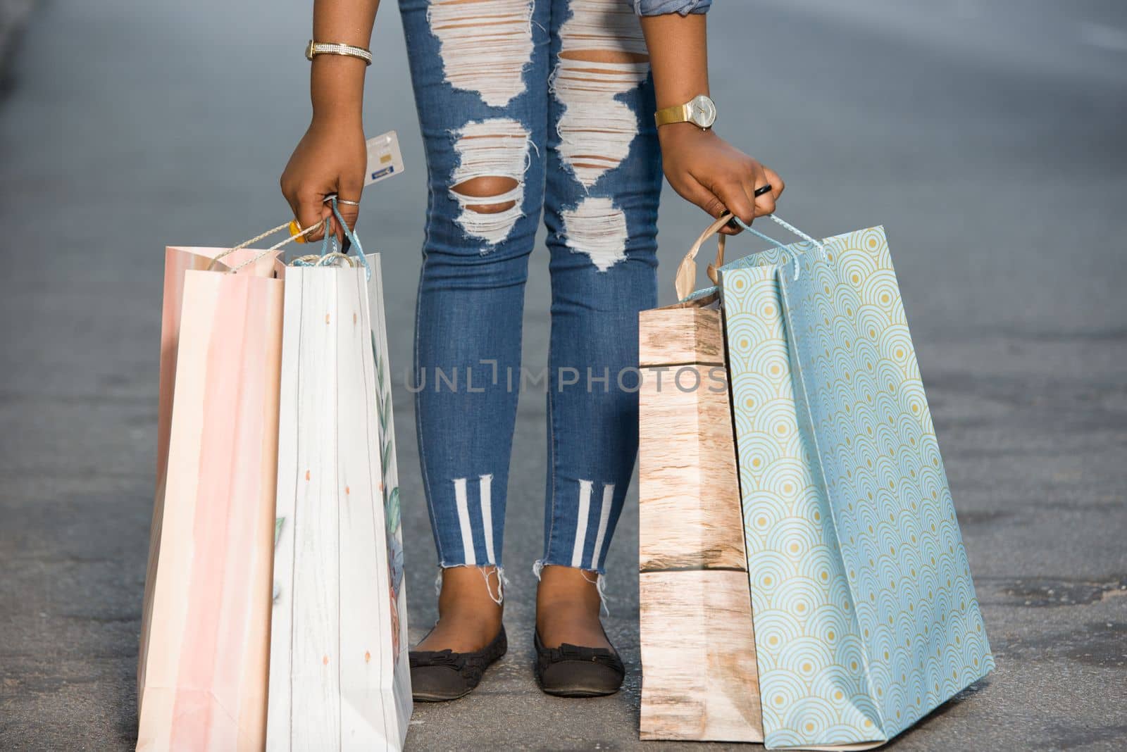 Girl standing in the street after shopping with shopping bags.