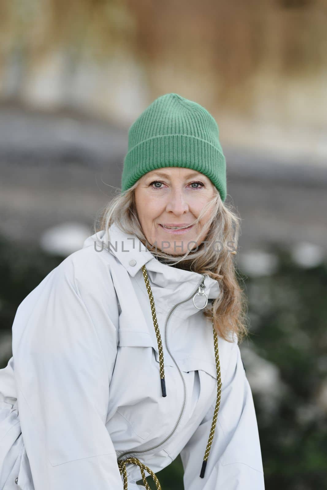 Portrait of a fifty-year-old woman with a white smile