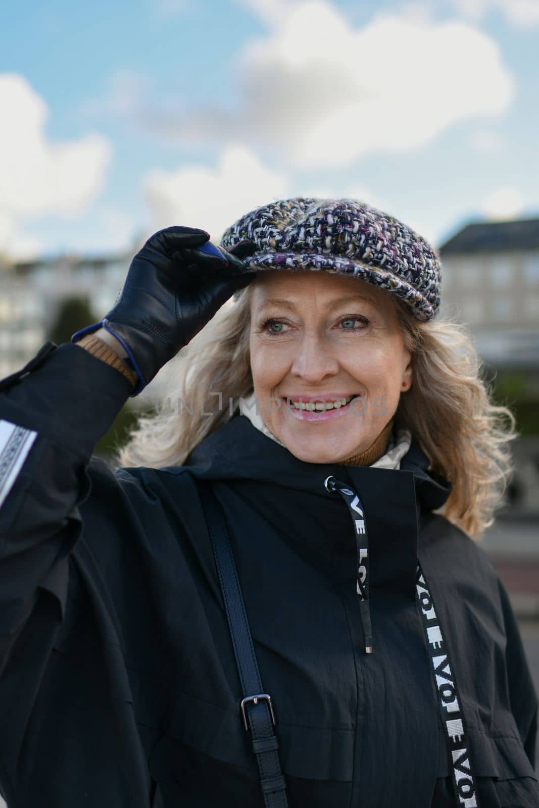 Portrait of a fifty-year-old woman with a white smile