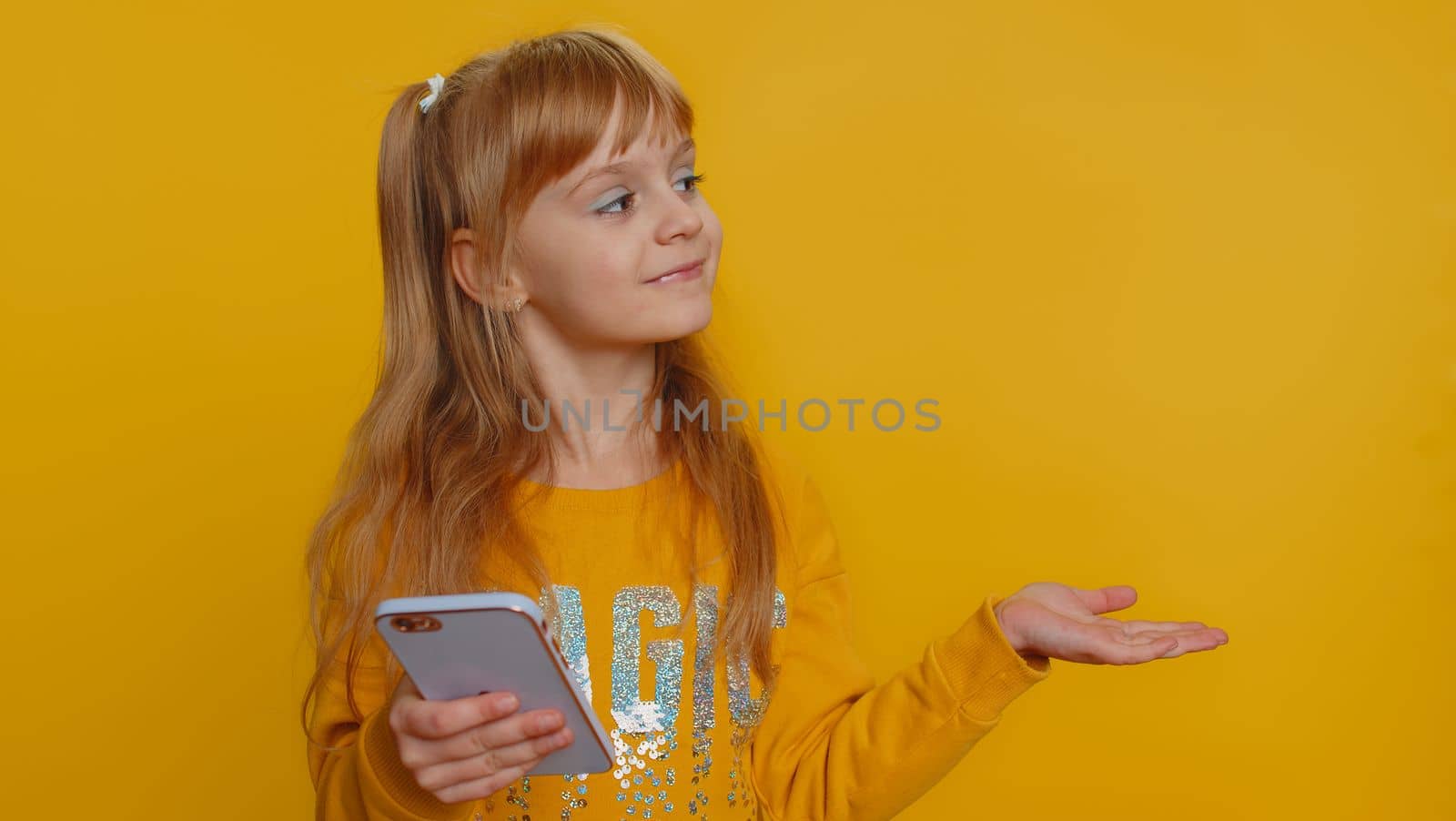Young preteen child girl kid using smartphone typing new post on web, browsing, searching, addiction of social networks, show thumbs up like, positive feedback, recommends wifi cellular connection 5G