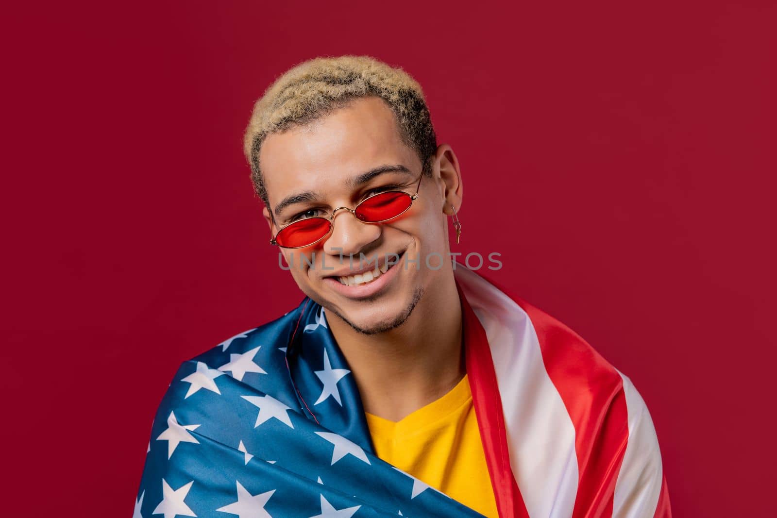 Happy man with national USA flag on red background. American patriot, 4th of July - Independence day celebration, election, America, labor. US banner. High quality photo