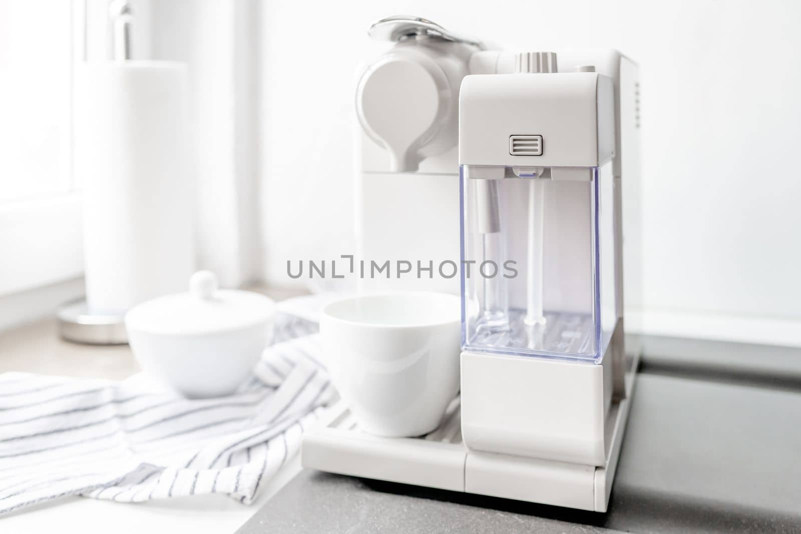 Coffee machine preparing cappuccino in white cup. Hot caffeint beverage lattee in mug for breakfast