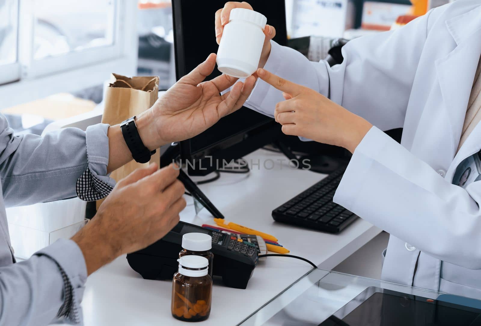 Closeup professional pharmacist advise or explain property of qualified medical product to customer in pharmacy, druggist answer to client healthcare inquiry, medical service and consultation concept.