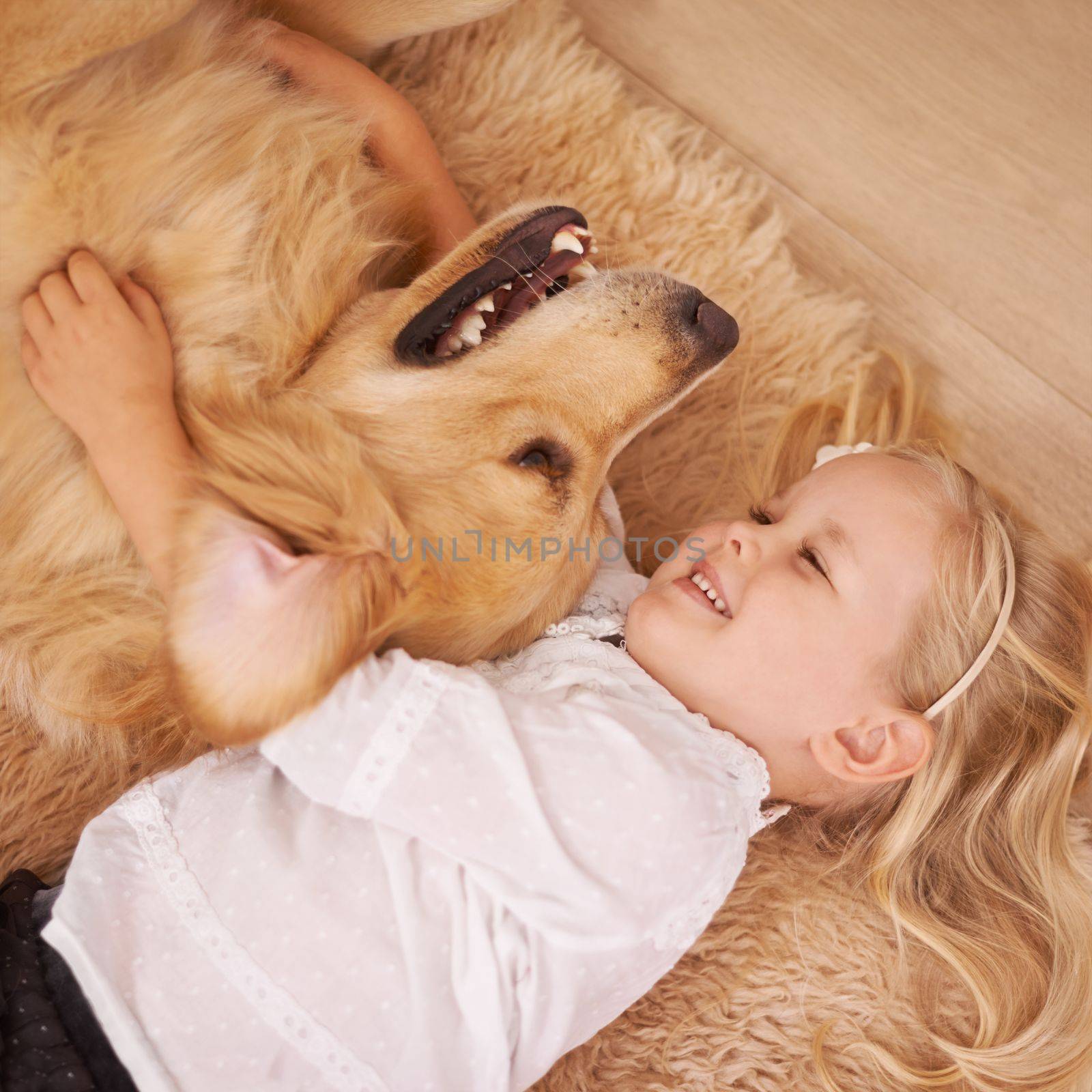 The best friend you can get. An adorable little girl with her dog at home