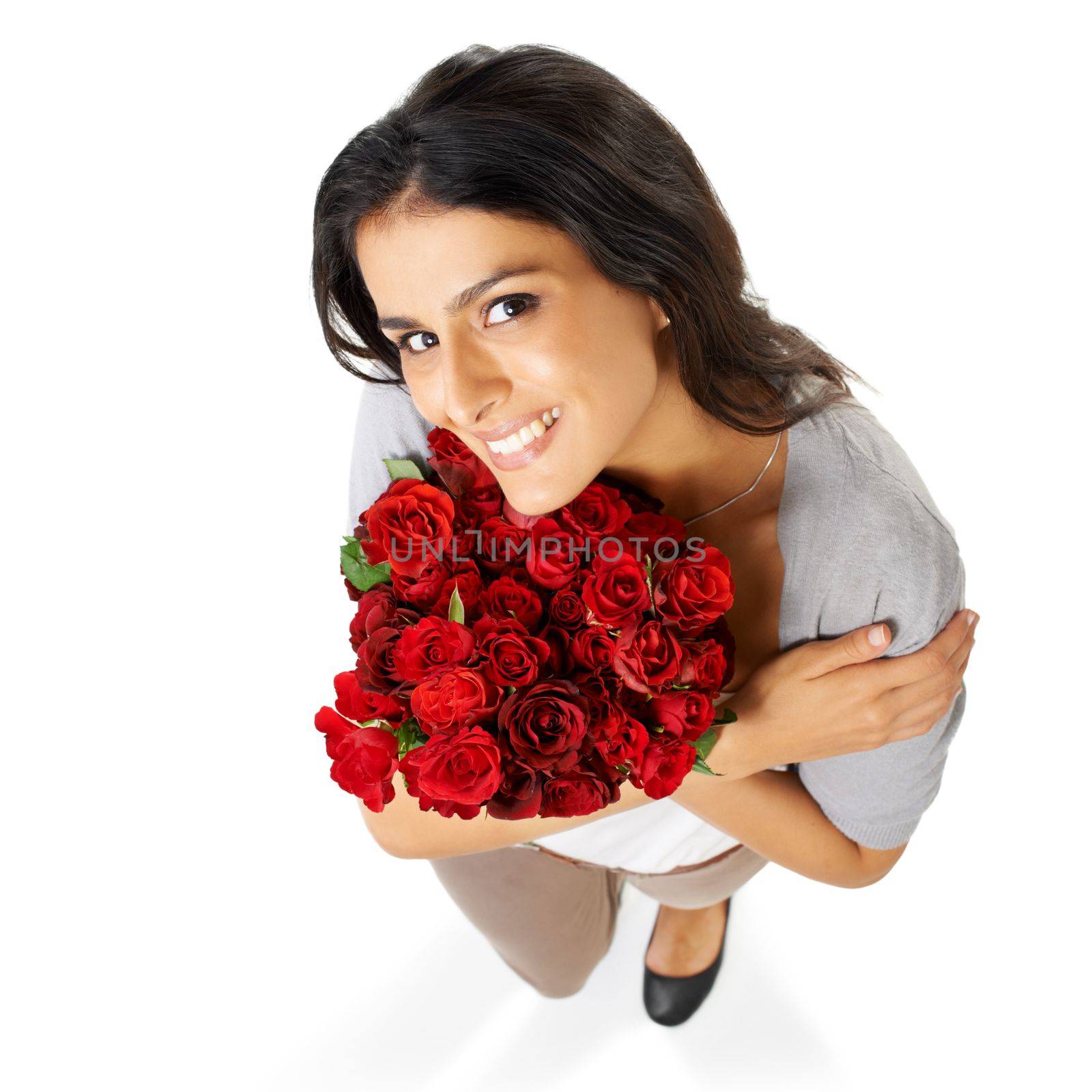 He loves me. A beautiful woman holding a bouquet of roses isolated on a white background