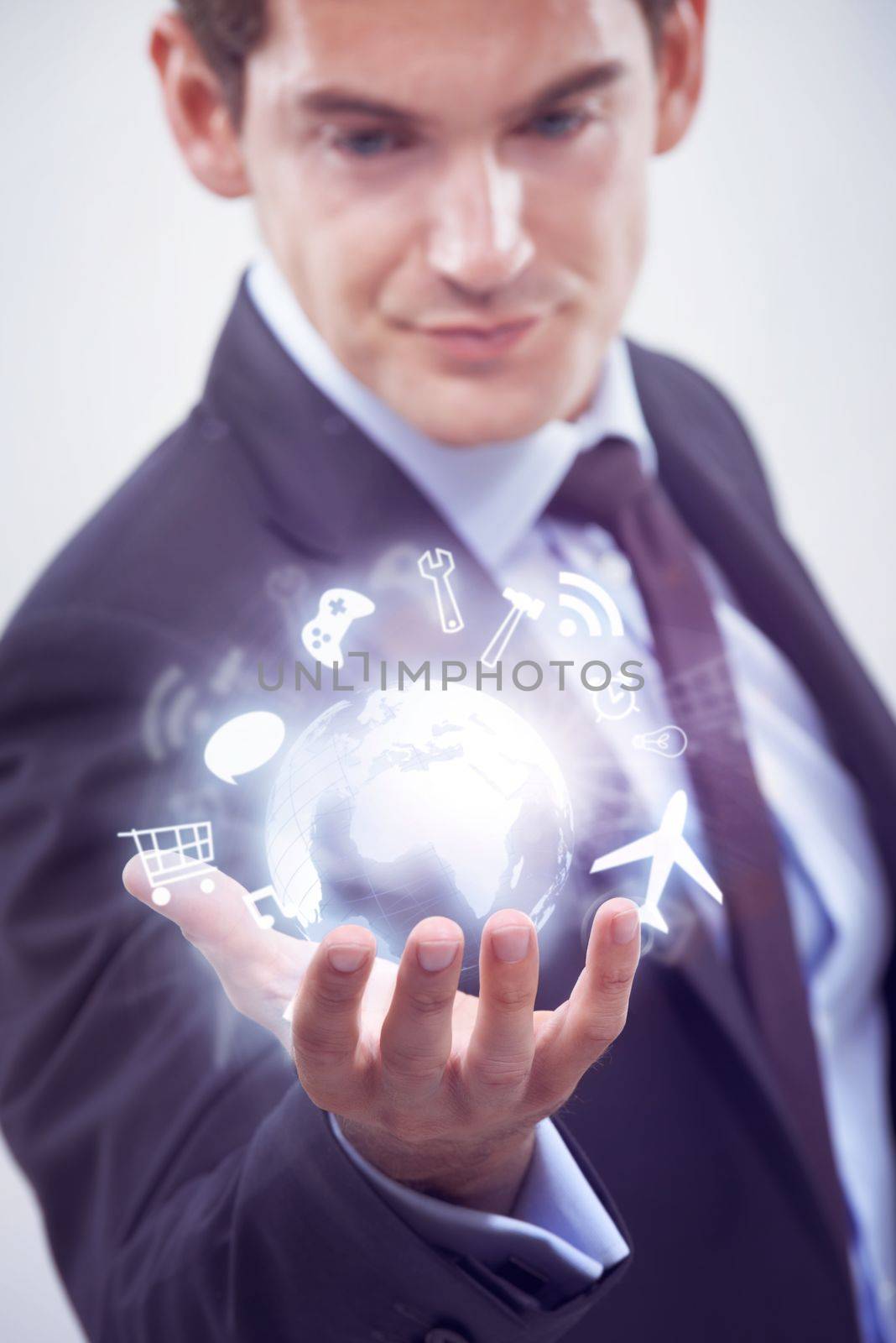Holding the future in his. A handsome young businessman using touchscreen technology