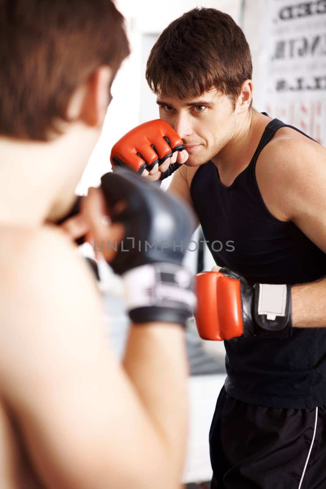 What winners are made of. two martial artists sparring in the ring. by YuriArcurs