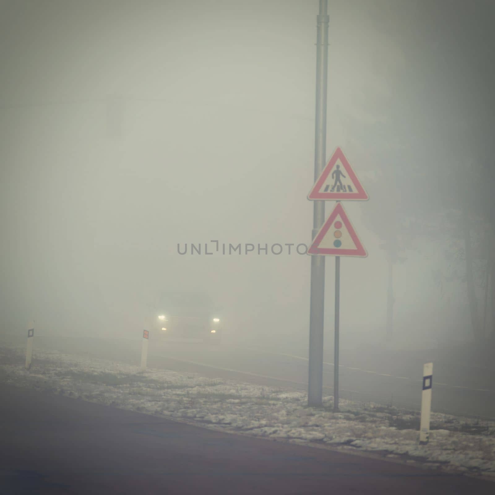 Cars in the fog. Traffic on the road in winter in bad weather. Dangers of driving cars. by Montypeter