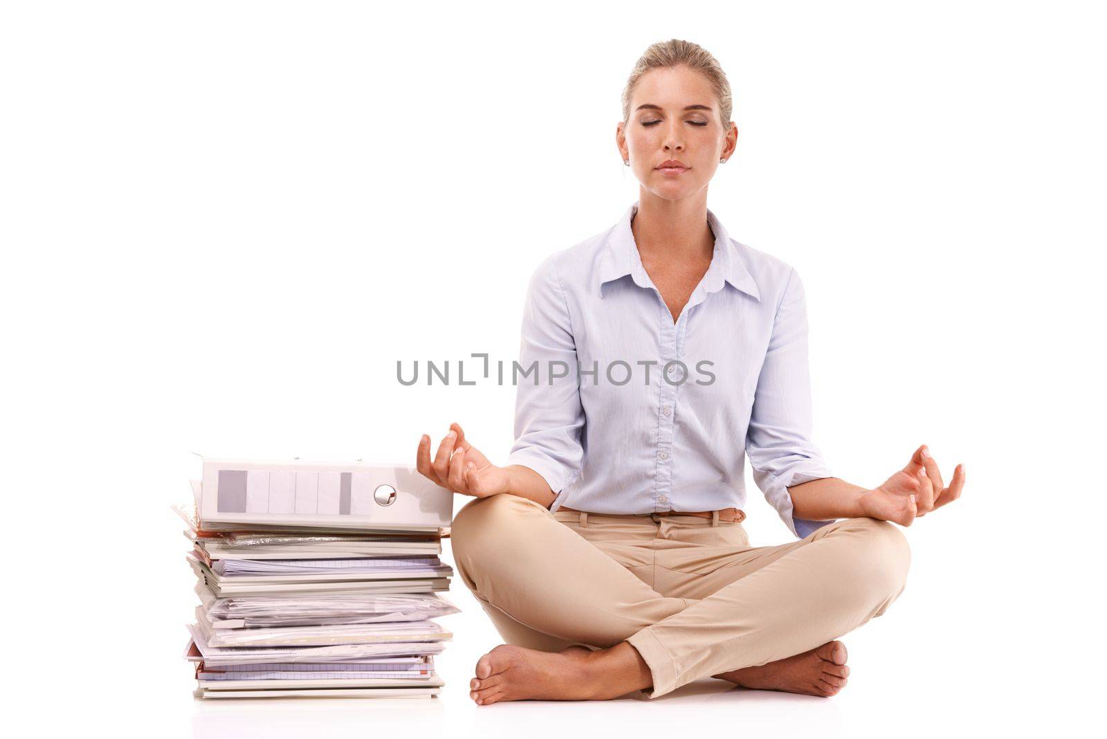 Yoga, documents and business woman meditation for work stress relief, mental health peace or chakra energy healing. Paperwork pile, relax zen mindset and mindfulness girl meditate on white background by YuriArcurs