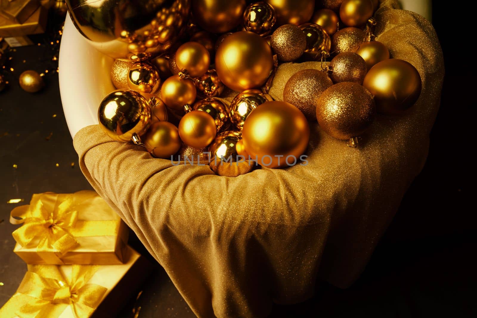 Bathtub full of golden balls. Vintage bright bathroom decorated with festive golden balls. New Year, Christmas bathroom interior