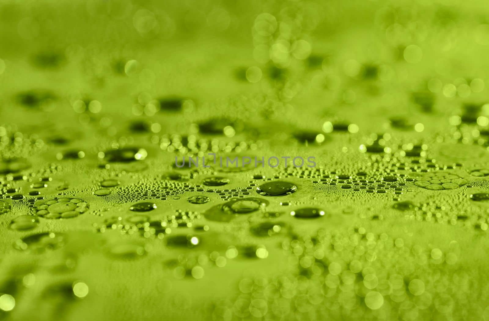 Water drops and air bubbles ,full frame , green abstract background