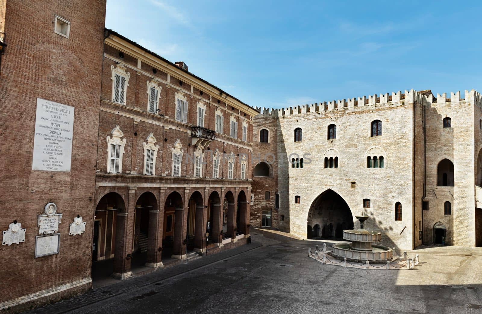 Fabriano ,Italy , Piazza del comune with gothic Palazzo del Podestà with swallow-tail battlements , Sturinalto Fountain and Vescovile Palace with Torre Civica