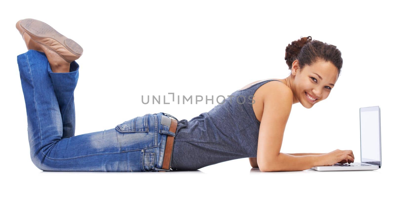 Portrait, laptop and student relax on studio floor for research, learning and project on white background. Study, education and girl typing, internet and search for creative, online and isolated.