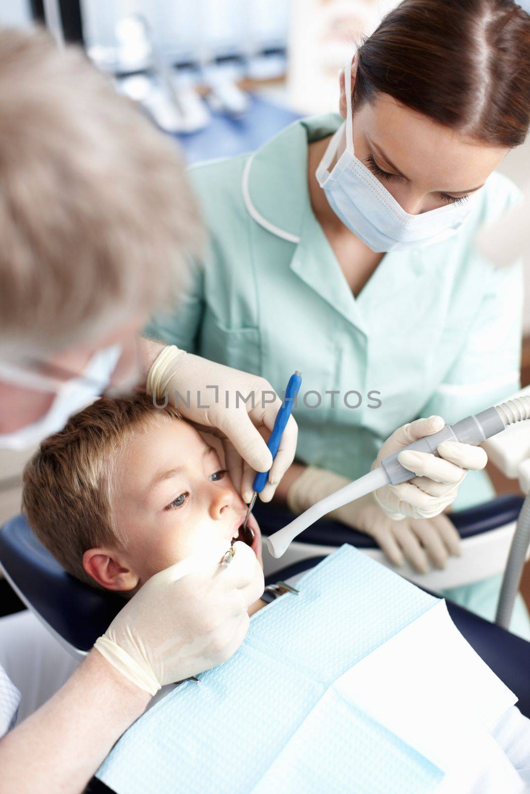 Young dental patient. Portrait of young dental patient taking treatment at dentist clinic