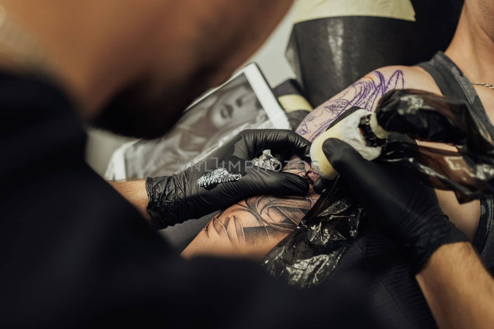 Close Up of Process of Creating Tattoo Art, Artist Draws on the Clients Skin by Romvy