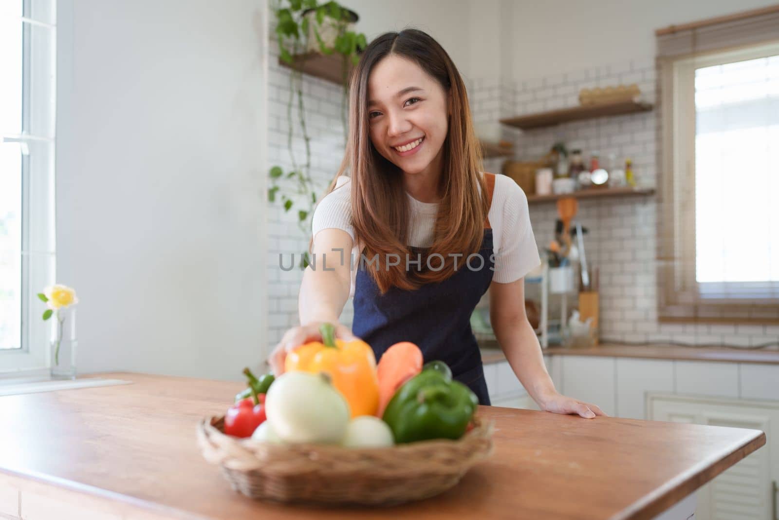 Portrait of beautiful young asian woman making salad at home. cooking food and Lifestyle moment by itchaznong