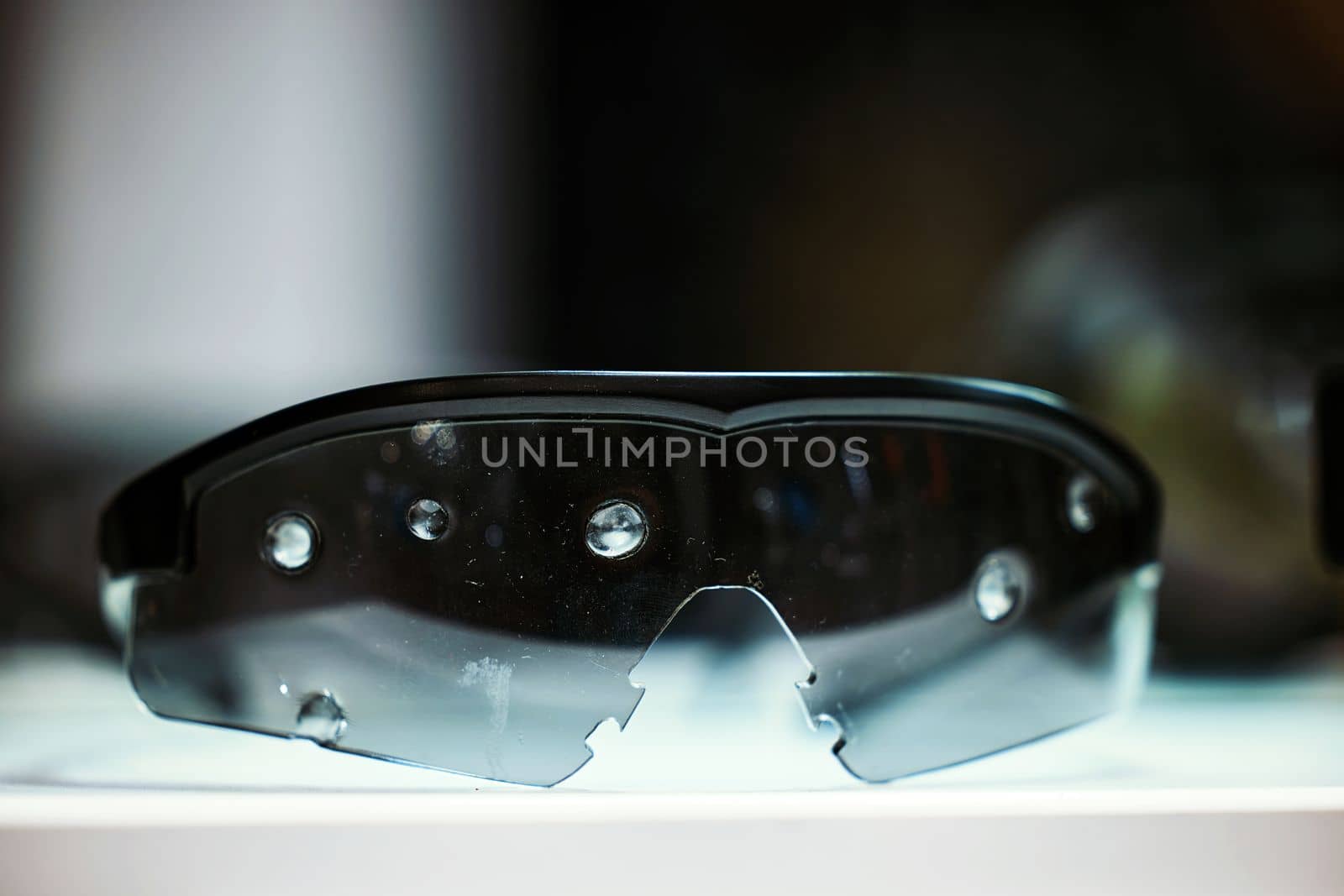 Safety goggles. Ballistic protective eyewear with plastic sunglasses. Protective ballistic goggles after testing. Protective sunglasses saved your eyes