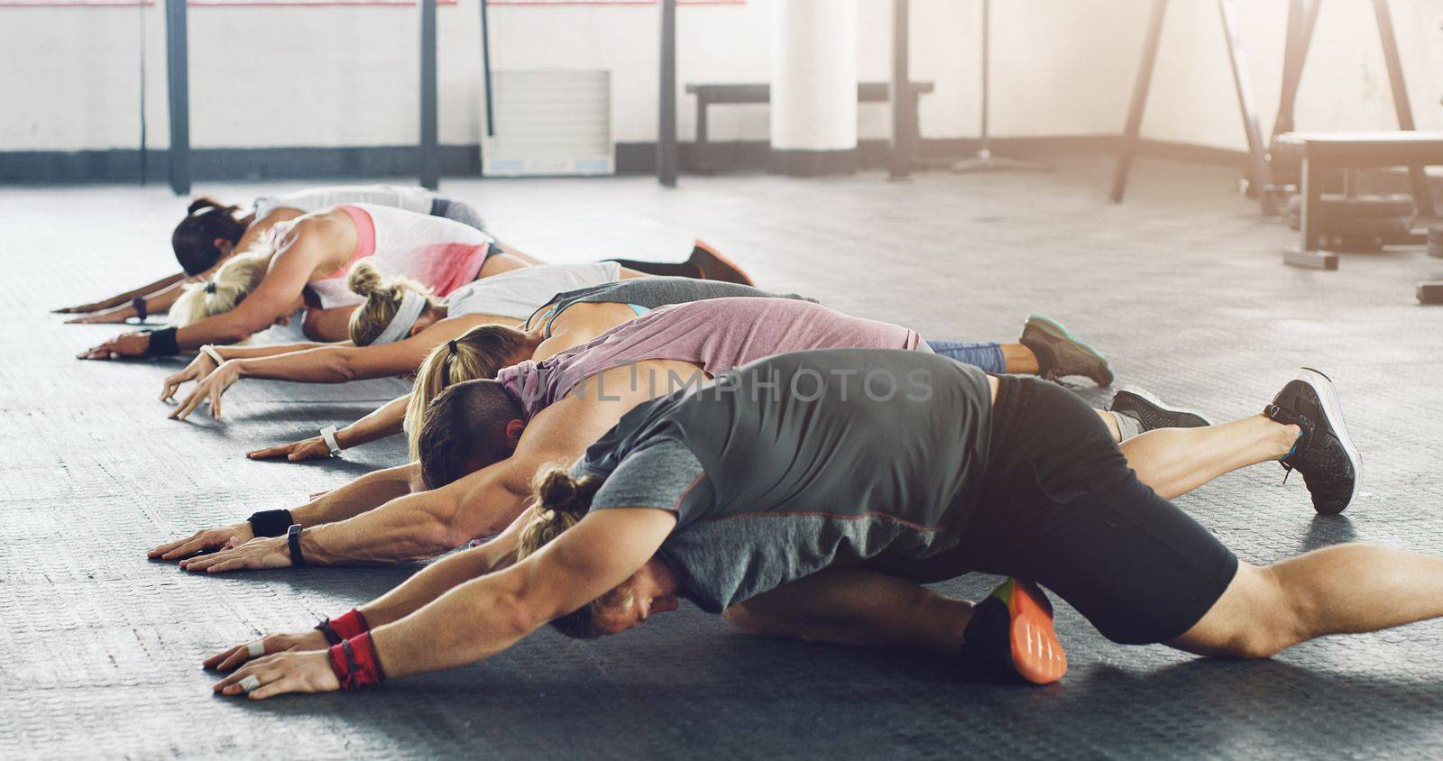 Bow down to the fitness gods at the workout temple. a group of young people working out together in a gym. by YuriArcurs
