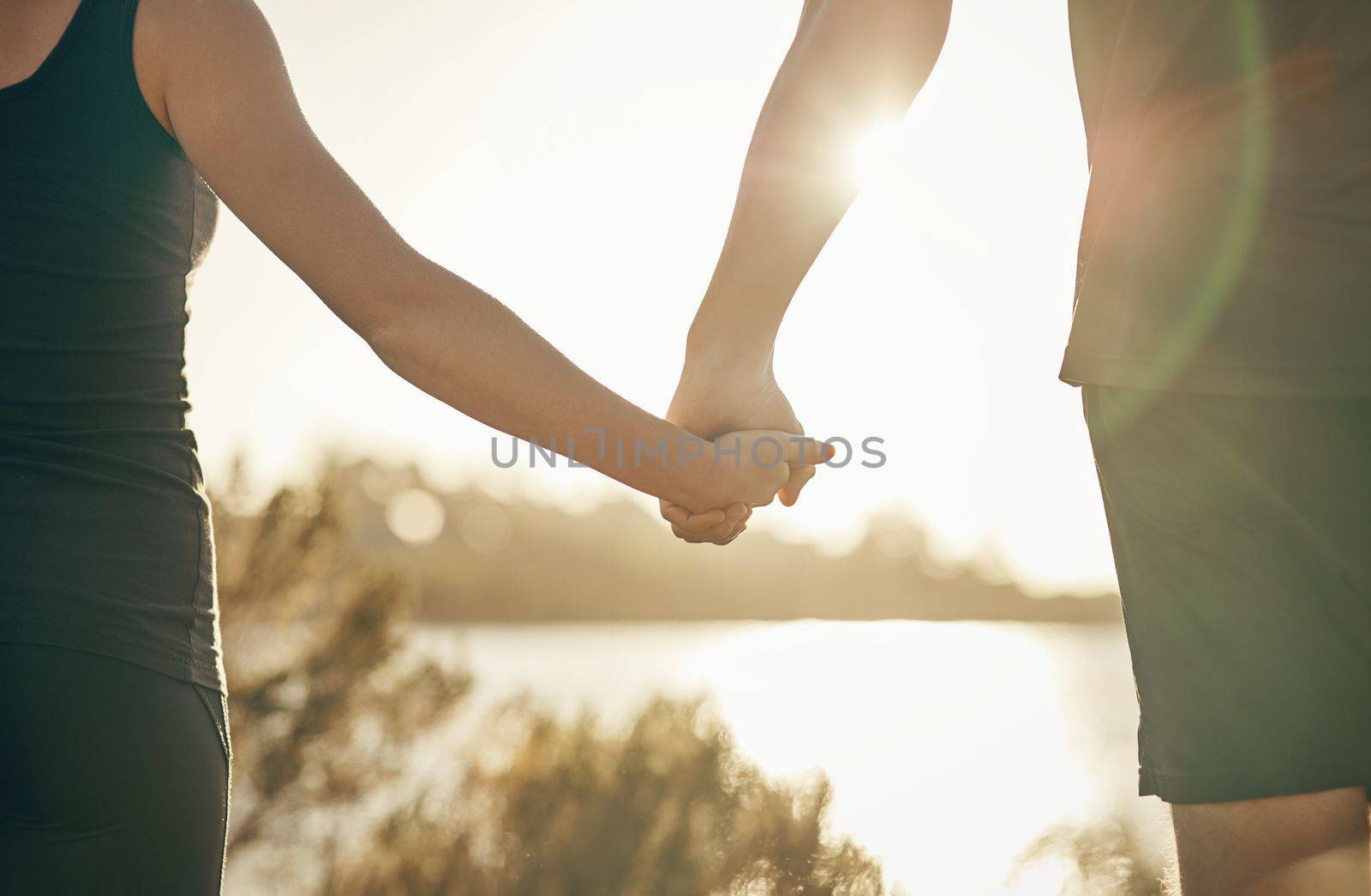 You me together, forever. a couple holding hands outdoors. by YuriArcurs