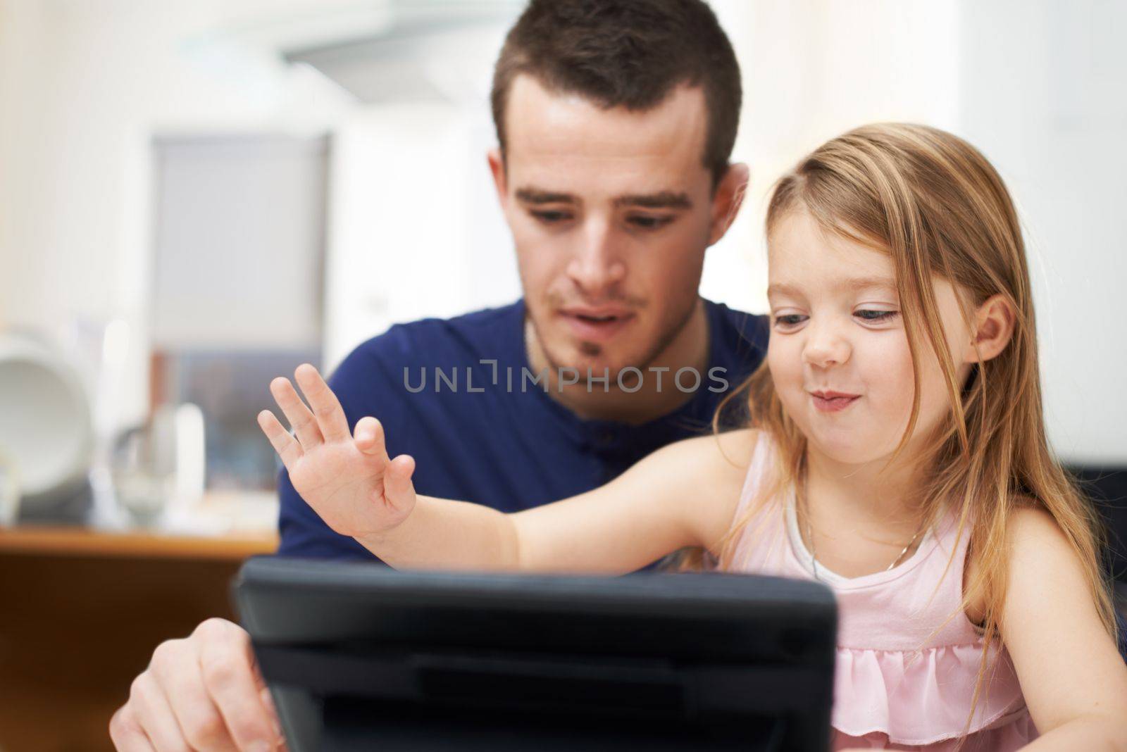 Yes but touch gently..A young girl and her father using technology together. by YuriArcurs