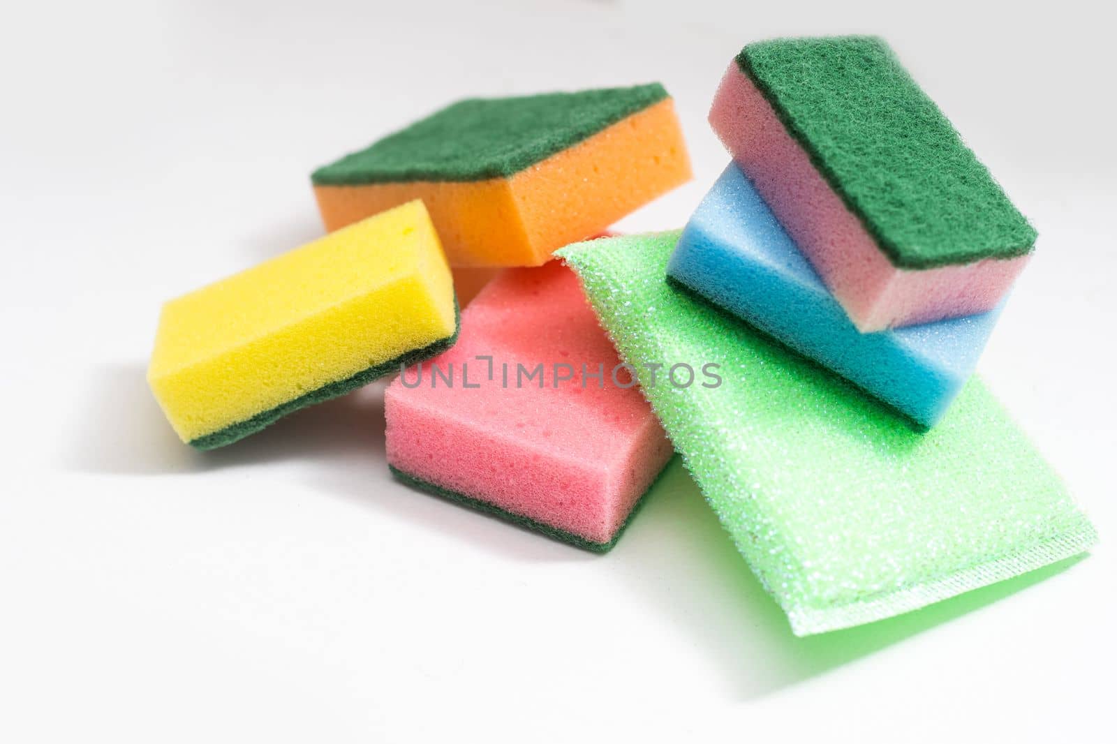 Kitchen dishcloth, cleanup concept, housework. Colorful kitchen sponges for cleaning close-up, housekeeping