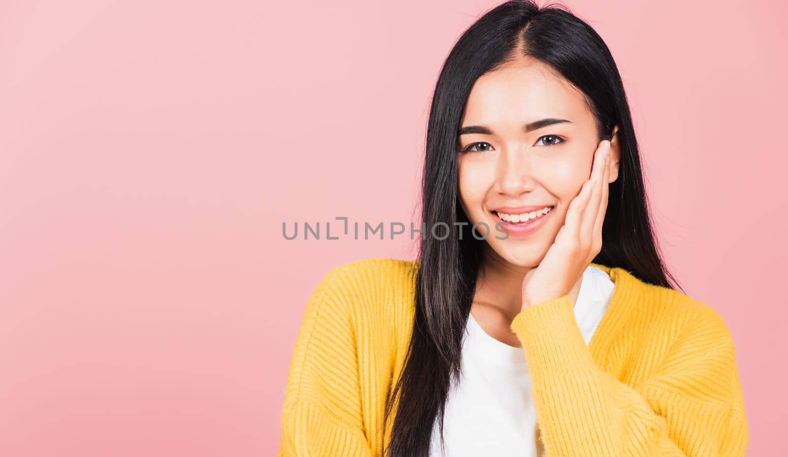 Happy Asian portrait beauty cute young woman teen smiling white teeth surprised excited celebrating gesturing palms on face studio shot isolated on pink background