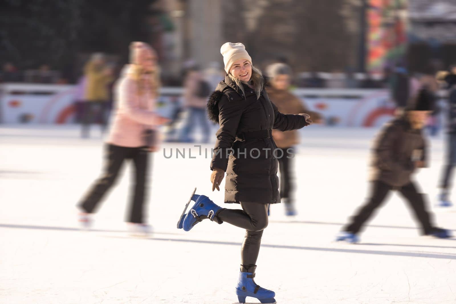 Happy smile woman roller skating Ice roller rink winter sunset