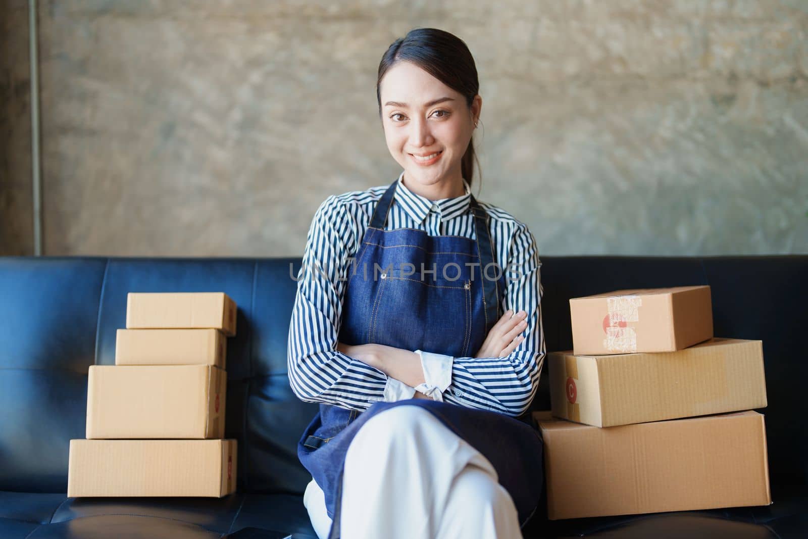 Starting small business entrepreneur of independent Asian female online seller packing products to send to customers and SME delivery concept by Manastrong