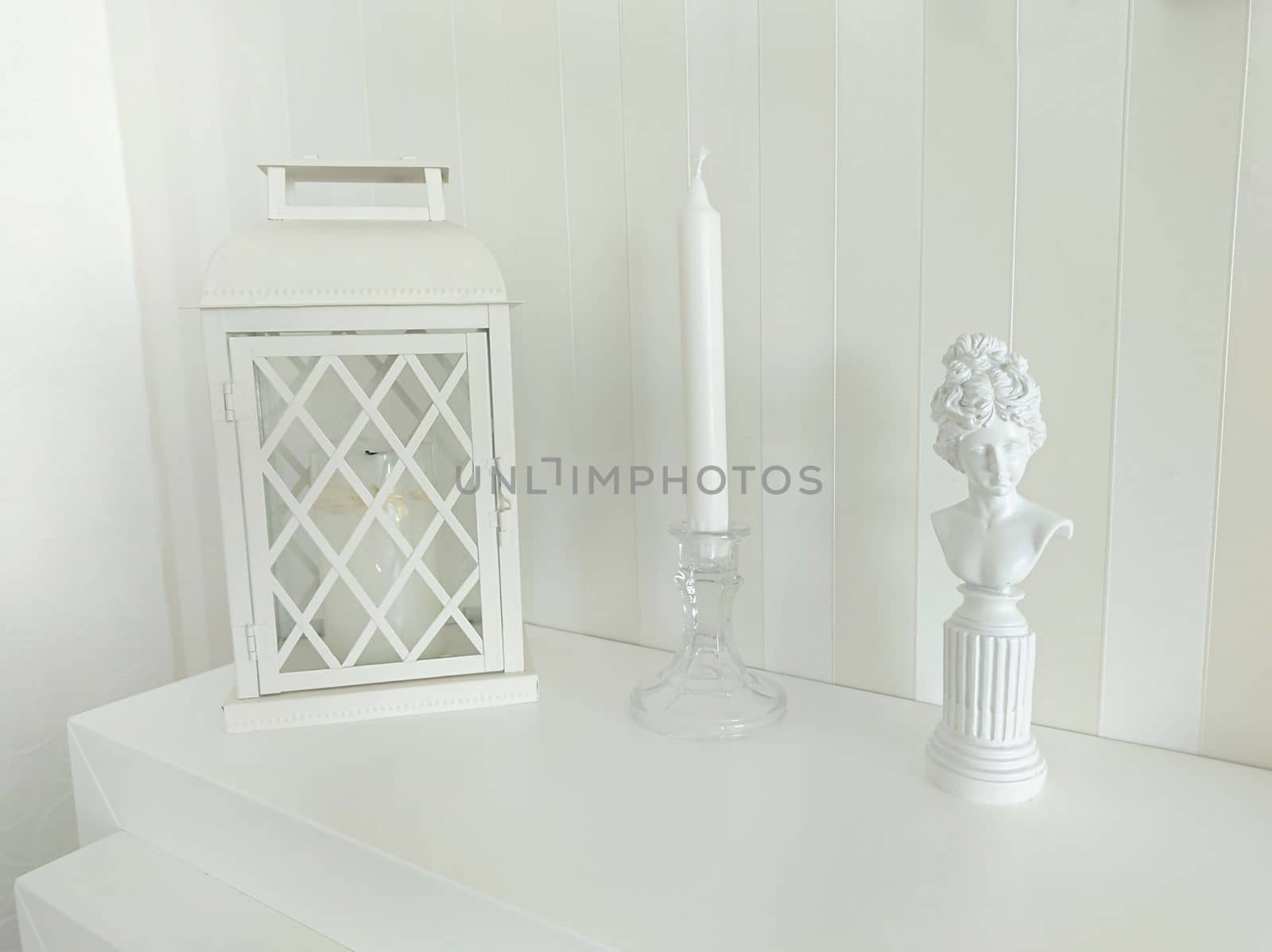 A beautiful composition with a place for text, with a candlestick, a lantern and a statuette of a woman.Texture or background