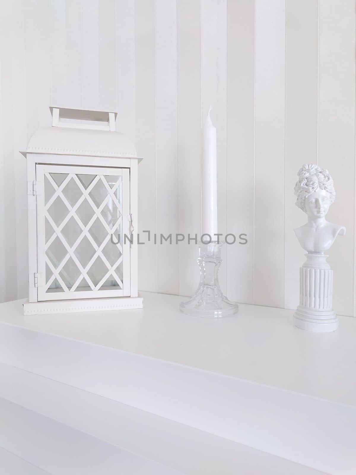 Texture or background. On the fireplace there is a lantern with a candlestick and a statuette of a woman from a long time ago