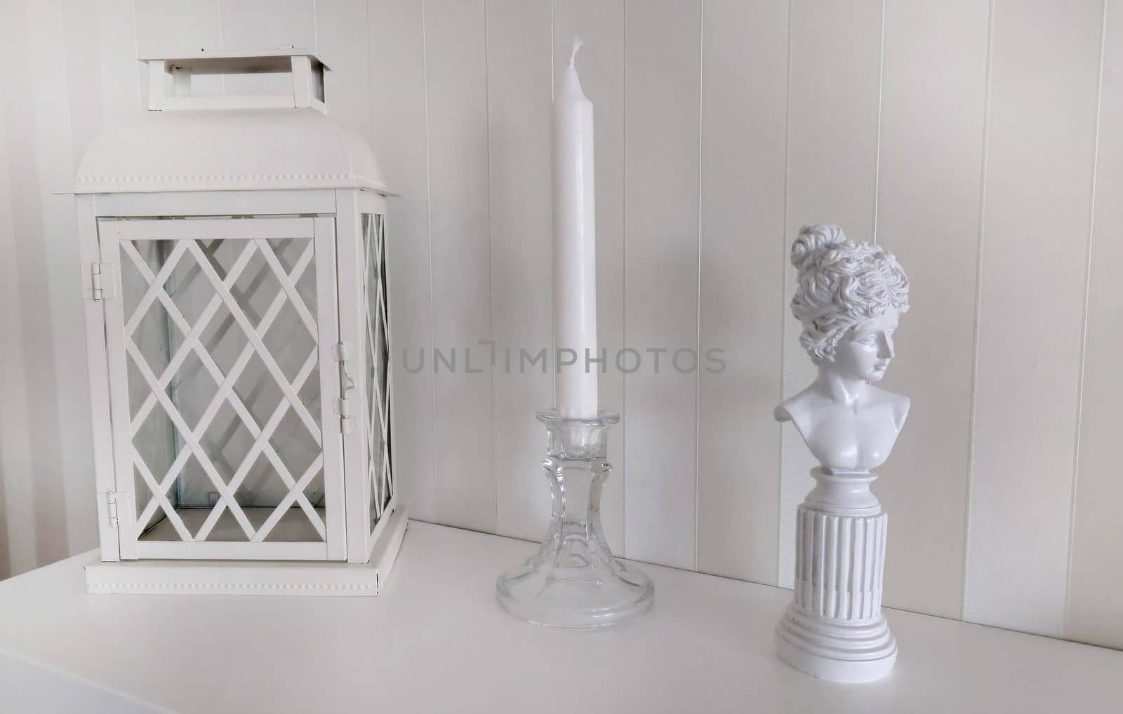 Texture or background.Home interior lantern with a candlestick and a statuette of a woman from bygone times