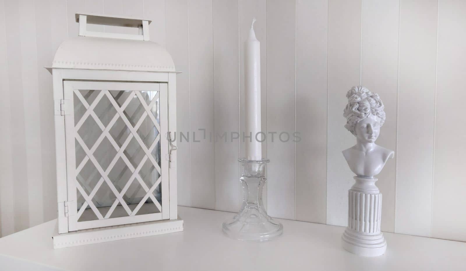 Texture or background.A composition with a lantern a candlestick and a statuette of a woman of bygone eras