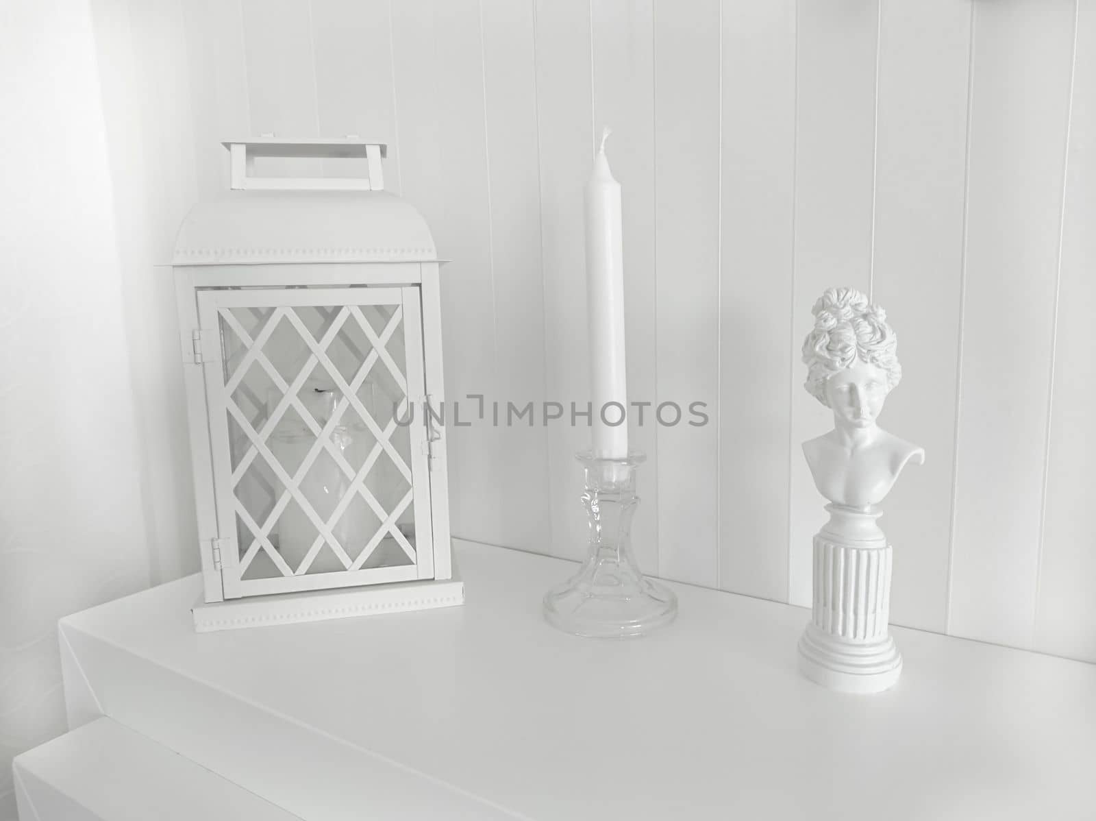 Texture or background.Composition on the fireplace with a lantern a candlestick and a statuette of a woman of bygone eras