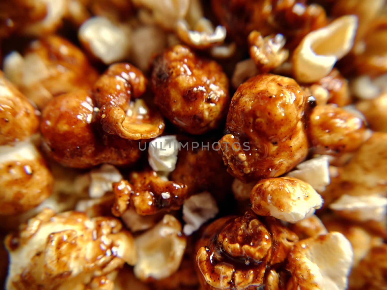 A handful of sweet popcorn with caramel close-up.Macro photography.Texture or background.Selective focus.