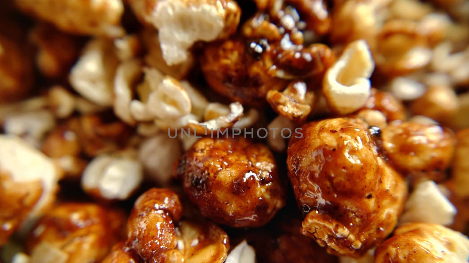 Sweet food a handful of popcorn with caramel close-up.Macro photography.Texture or background.Selective focus.