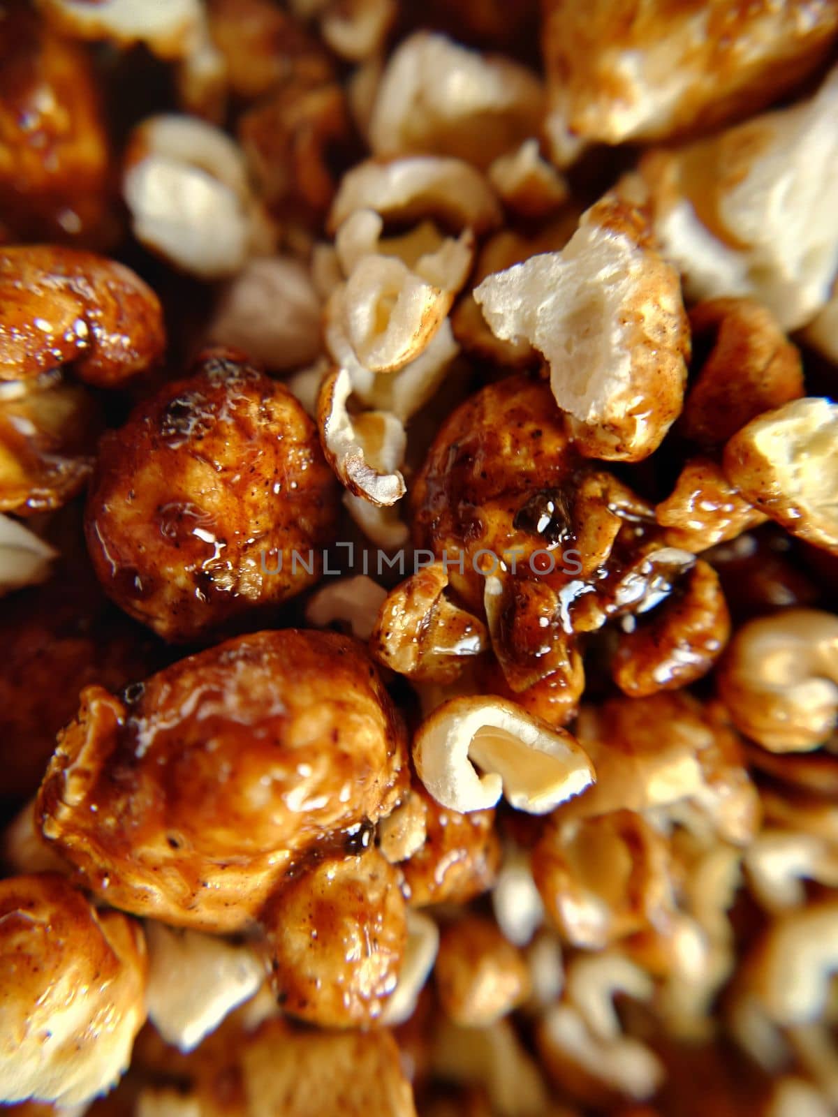 A handful of brown popcorn with caramel close-up.Macro photography.Texture or background.Selective focus.