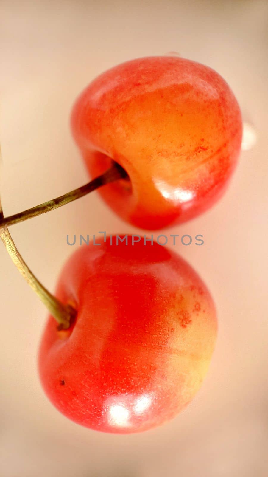 Ripe red-yellow cherries selectively stand out against a light background.Macro photography.Texture or background.Selective focus.