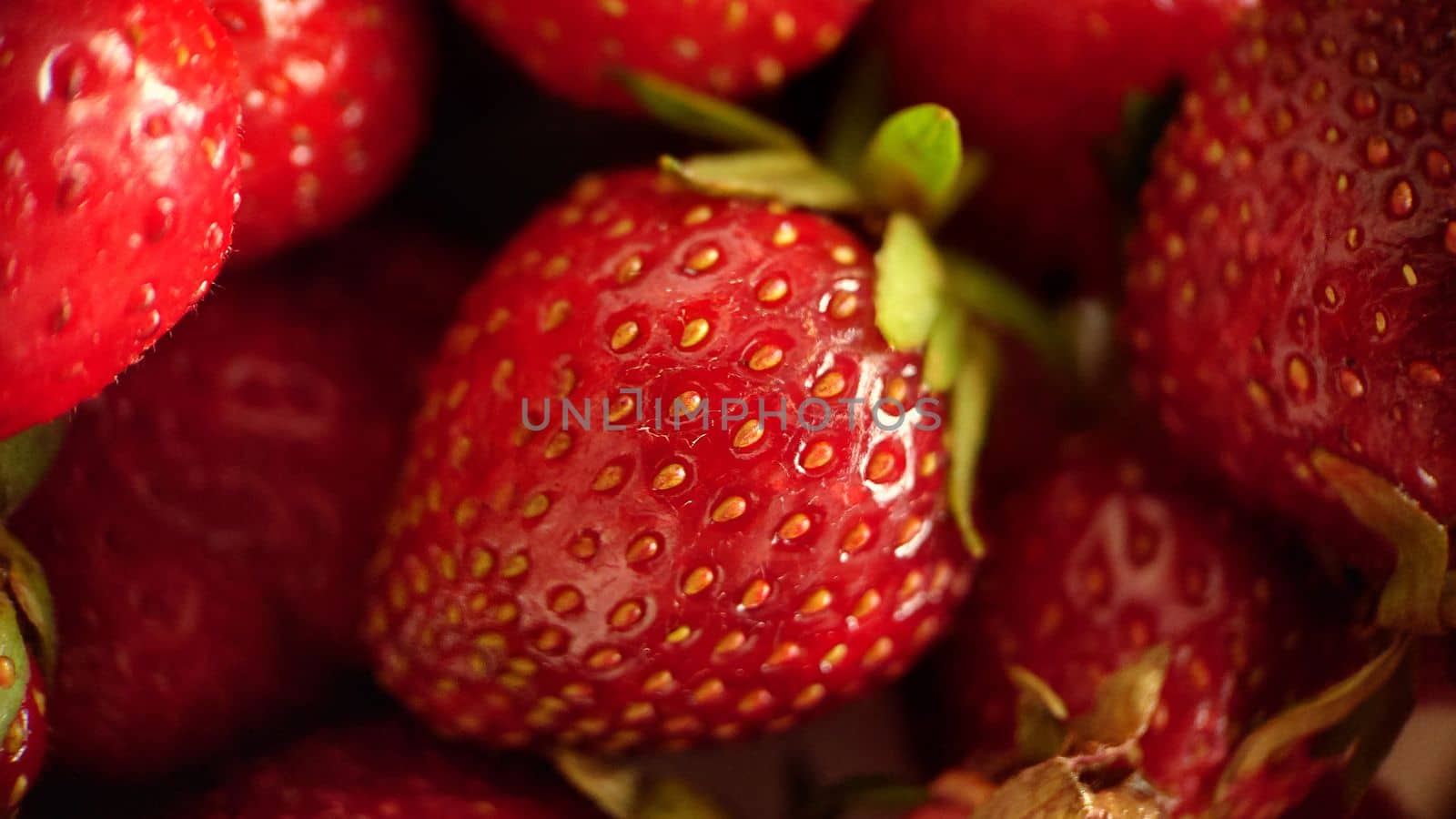 Background image of ripe juicy strawberries in close-up.Macro photography.Texture or background.Selective focus.