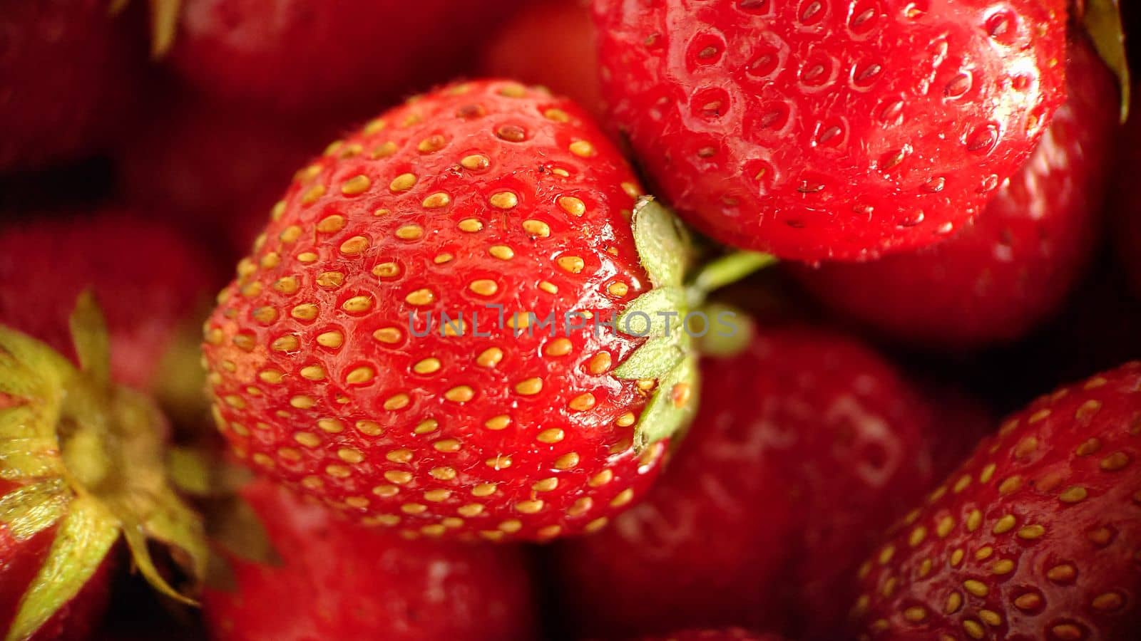 Juicy ripe strawberry berry selective focus close-up.Macrophotography.Texture or background. Selective focus.