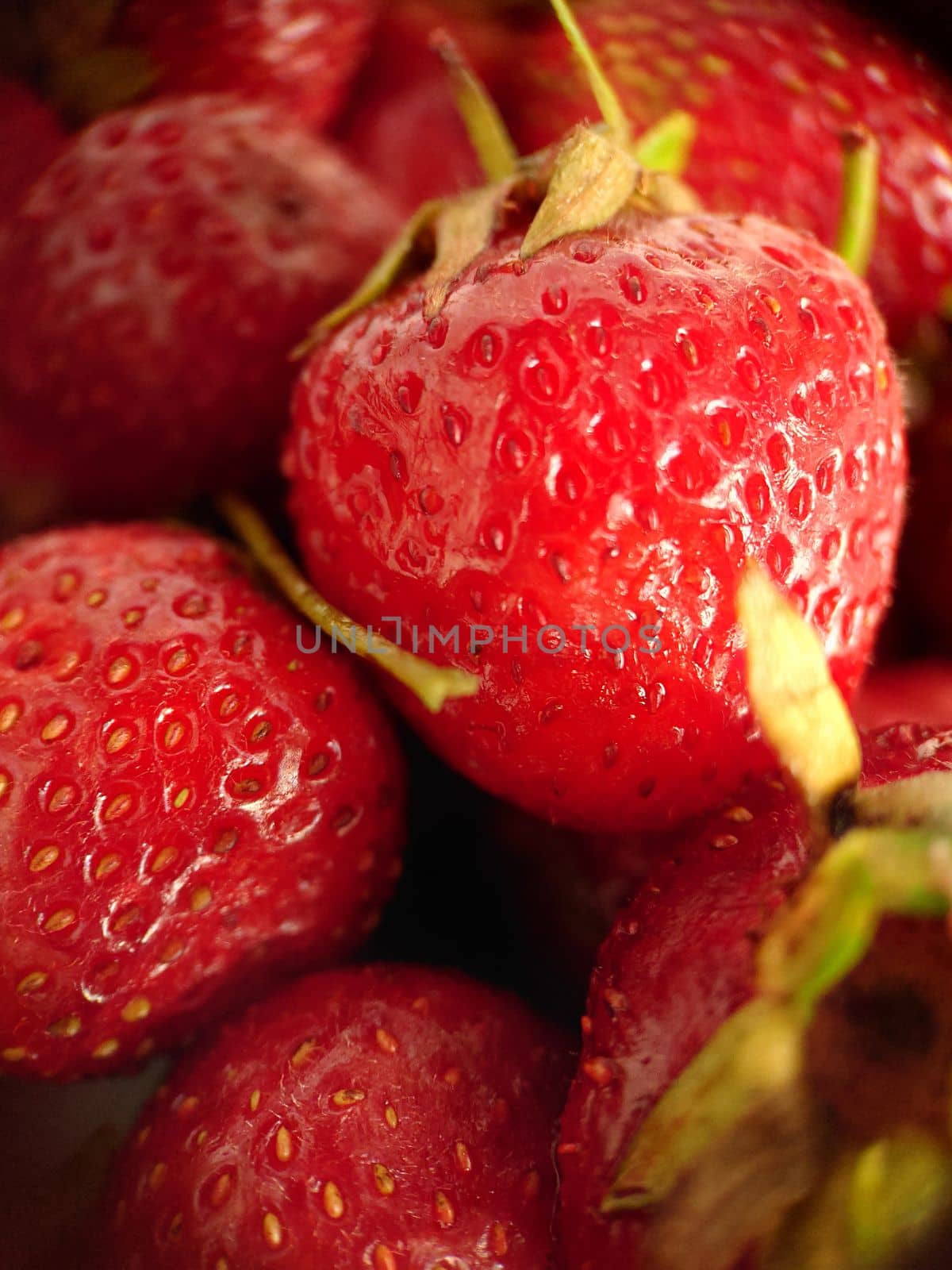 Juicy ripe strawberry berry selective focus close-up.Macrophotography.Texture or background. Selective focus.