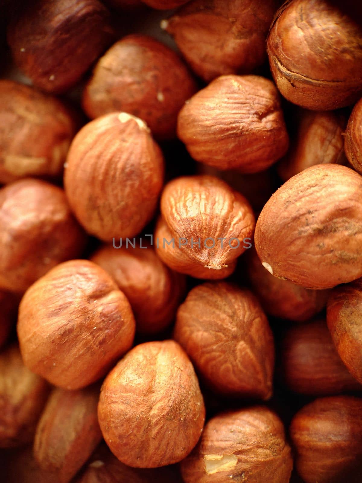 A handful of hazelnuts peeled from the shell in close-up.Macrophotography.Texture or background. Selective focus.