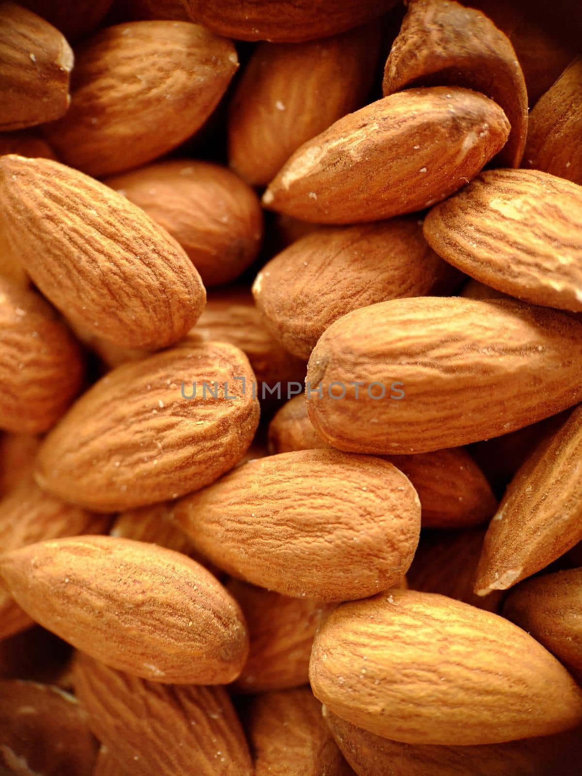 A handful of large almonds close-up selective focus.Macrophotography.Texture or background. Selective focus.