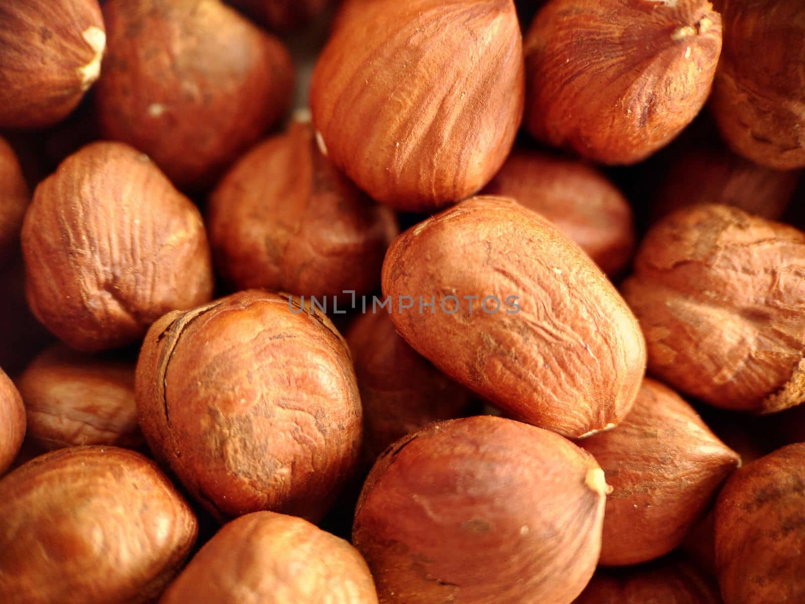 Close-up of a handful of hazelnuts peeled from the shell.Macrophotography.Texture or background. Selective focus.